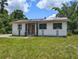 Quaint single-story home featuring a grass front yard and a traditional-style entrance at 12704 Lacey, New Port Richey, FL 34654