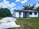 Quaint single-story home with neutral siding, grassy front yard, and a long, inviting driveway at 12704 Lacey, New Port Richey, FL 34654