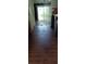 Interior view of a room featuring damaged hardwood flooring, a sliding glass door, and wooden cabinetry at 12704 Lacey, New Port Richey, FL 34654