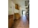 Galley kitchen showcasing wood cabinets, laminate floors, and view to back, ready for renovation at 12704 Lacey, New Port Richey, FL 34654