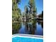 Calm lake view with lush trees and glimpses of homes, captured from the edge of a boat at 12704 Lacey, New Port Richey, FL 34654