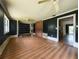Spacious living room with brick accent, laminate floors, and ceiling fans, needs work at 12704 Lacey, New Port Richey, FL 34654