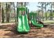 Community playground featuring two slides for Gathering fun in a natural setting at 12704 Lacey, New Port Richey, FL 34654