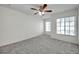 Bedroom featuring carpet, two windows, and a ceiling fan at 1302 Twilridge Pl, Brandon, FL 33511