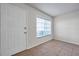 Bright entryway featuring tile flooring, a white door, and a window allowing natural light to fill the space at 1302 Twilridge Pl, Brandon, FL 33511