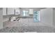 Bright kitchen boasts white cabinets, modern appliances, and a granite breakfast bar at 1302 Twilridge Pl, Brandon, FL 33511