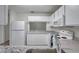 All-white kitchen featuring a breakfast bar, plenty of storage, and stainless steel appliances at 1302 Twilridge Pl, Brandon, FL 33511