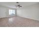 Bright living room with tile flooring, a ceiling fan, and a front door, creating an inviting atmosphere at 1302 Twilridge Pl, Brandon, FL 33511