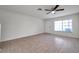 Open-concept living area with tile flooring, a ceiling fan, and ample natural light streaming through a window at 1302 Twilridge Pl, Brandon, FL 33511