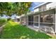 View of a screened patio extending into a lush green lawn at 1302 Twilridge Pl, Brandon, FL 33511