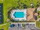 Aerial view of the community pool with plenty of seating, green landscaping, and parking at 1302 Twilridge Pl, Brandon, FL 33511