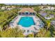 Overhead view of the community pool area featuring chairs, lush greenery, and a common building at 1302 Twilridge Pl, Brandon, FL 33511