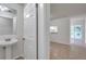 Well-lit powder room featuring a vanity sink, mirror, and convenient access to other living spaces at 1302 Twilridge Pl, Brandon, FL 33511