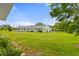 Expansive backyard featuring lush lawn, garden, and vibrant landscaping at 1306 Idlewood Dr # 53, Sun City Center, FL 33573