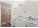 Bathroom featuring marble countertops, double sinks, and a glass-enclosed shower at 1306 Idlewood Dr # 53, Sun City Center, FL 33573