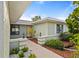 Inviting walkway leading to the front door surrounded by lush landscaping at 1306 Idlewood Dr # 53, Sun City Center, FL 33573