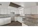 Modern kitchen with sleek white cabinets, granite countertops, and stainless steel sink at 1306 Idlewood Dr # 53, Sun City Center, FL 33573
