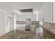 Beautiful kitchen with white cabinetry, granite countertops, and a skylight at 1306 Idlewood Dr # 53, Sun City Center, FL 33573