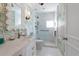 Elegant bathroom featuring a glass shower, marble vanity, and botanical wallpaper at 1508 S Howard Ave # A, Tampa, FL 33606