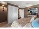 View of bedroom with white closet doors, decorative chest and neutral decor at 1508 S Howard Ave # A, Tampa, FL 33606