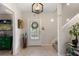 Warm entryway featuring a tiled floor, staircase, and stylish decor at 1508 S Howard Ave # A, Tampa, FL 33606