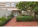 Charming front yard with brick walkway, statue, mature tree and lush landscaping at 1508 S Howard Ave # A, Tampa, FL 33606