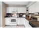 Charming kitchen featuring white appliances, tile floors, and neutral countertops at 1508 S Howard Ave # A, Tampa, FL 33606