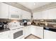 Charming kitchen featuring white appliances, tile floors, and neutral countertops at 1508 S Howard Ave # A, Tampa, FL 33606