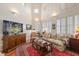 Open-concept living room with hardwood floors, high ceilings, and large windows that let in natural light at 1508 S Howard Ave # A, Tampa, FL 33606