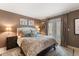 Comfortable main bedroom with a king bed, decorative pillows, and access to the outdoors at 1508 S Howard Ave # A, Tampa, FL 33606