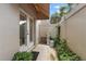 Cozy patio with stone statue, lush greenery, privacy fence and french doors at 1508 S Howard Ave # A, Tampa, FL 33606
