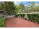 Secluded brick patio with ivy-covered walls and ornamental statuary at 1508 S Howard Ave # A, Tampa, FL 33606