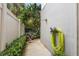 View of side yard with lush hedges and a mounted hose reel at 1508 S Howard Ave # A, Tampa, FL 33606