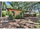 Landscaped backyard featuring a deck and pergola, creating a perfect outdoor retreat at 1530 Erin Ln, Clearwater, FL 33755