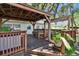 Backyard deck area featuring a cozy pergola, hot tub, and relaxing ambiance at 1530 Erin Ln, Clearwater, FL 33755
