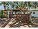 Cozy backyard deck featuring a wooden pergola, great for entertaining or enjoying the outdoors at 1530 Erin Ln, Clearwater, FL 33755