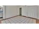 Bedroom showcasing tile flooring, white walls, doors and a glimpse into the bathroom at 1530 Erin Ln, Clearwater, FL 33755