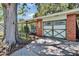 Home exterior showcasing a unique garage door design and well-kept landscaping at 1530 Erin Ln, Clearwater, FL 33755