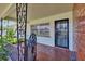 Inviting front porch with decorative ironwork and tiled flooring, offering a charming entrance at 1530 Erin Ln, Clearwater, FL 33755