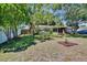 Spacious front yard with mature trees, providing shade and enhancing the property's appeal at 1530 Erin Ln, Clearwater, FL 33755