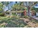 Ranch-style home with a mature tree, well-maintained lawn, and inviting curb appeal at 1530 Erin Ln, Clearwater, FL 33755