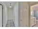 Hallway with black and white patterned flooring, and doors leading to other rooms at 1530 Erin Ln, Clearwater, FL 33755