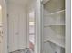 Bright hallway featuring a utility closet and doorway with access to the kitchen at 1530 Erin Ln, Clearwater, FL 33755