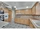 Kitchen view featuring wooden cabinets, patterned tile flooring, oven and ample counter space at 1530 Erin Ln, Clearwater, FL 33755