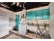 This laundry room features a washer, utility sink, cabinets, and a bright, turquoise door at 1530 Erin Ln, Clearwater, FL 33755