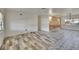 Open living area with a blend of patterned tile and wood-look flooring, offering versatile style at 1530 Erin Ln, Clearwater, FL 33755