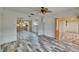 Spacious living room featuring wood-style flooring and view into an adjacent kitchen at 1530 Erin Ln, Clearwater, FL 33755