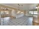 Spacious living room featuring decorative tile flooring, pendant lighting, and an open layout at 1530 Erin Ln, Clearwater, FL 33755