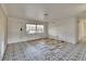 Bright living room featuring stylish tile flooring and a freshly painted front door at 1530 Erin Ln, Clearwater, FL 33755