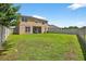 A view of the large backyard features a patio area, providing ample room for outdoor recreation and relaxation at 19028 Narimore Dr, Land O Lakes, FL 34638
